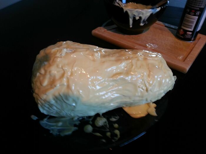 A DIY fail: a lumpy, shapeless cake covered in white frosting, clearly a baking attempt that went wrong.