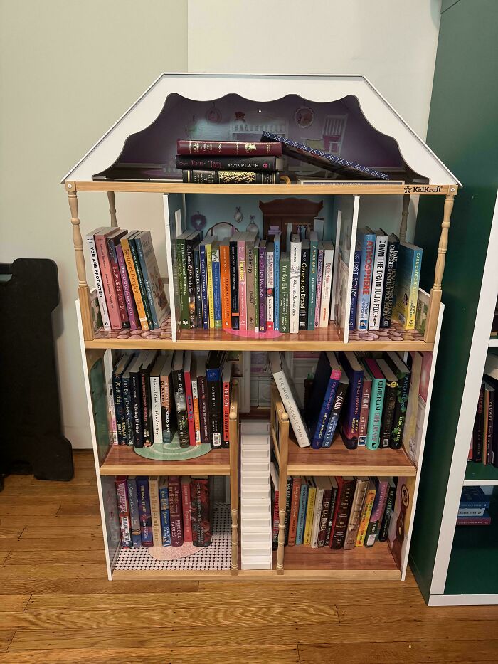 Dollhouse bookshelf filled with colorful books showcasing quirky projects