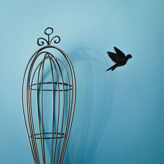 A kitchen whisk reimagined as a birdcage in playful illustrations by Romain Joly