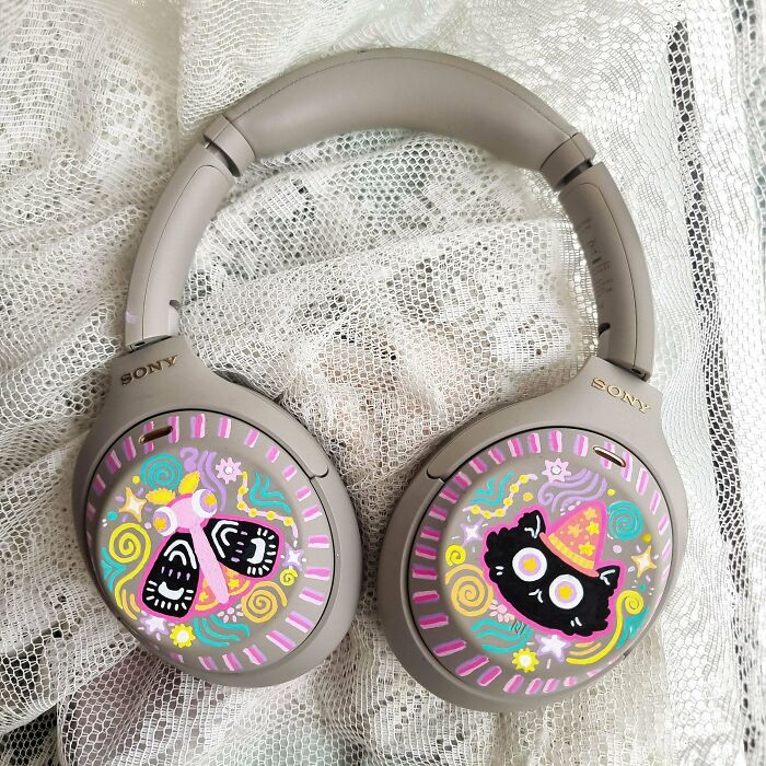 Sony headphones decorated with colorful cat and butterfly designs, quirky projects art