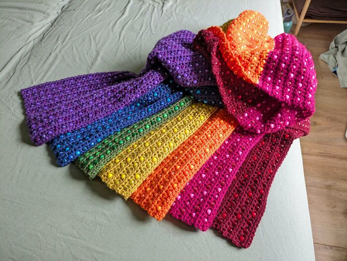Colorful crocheted scarf with rainbow colors and textured bobbles
