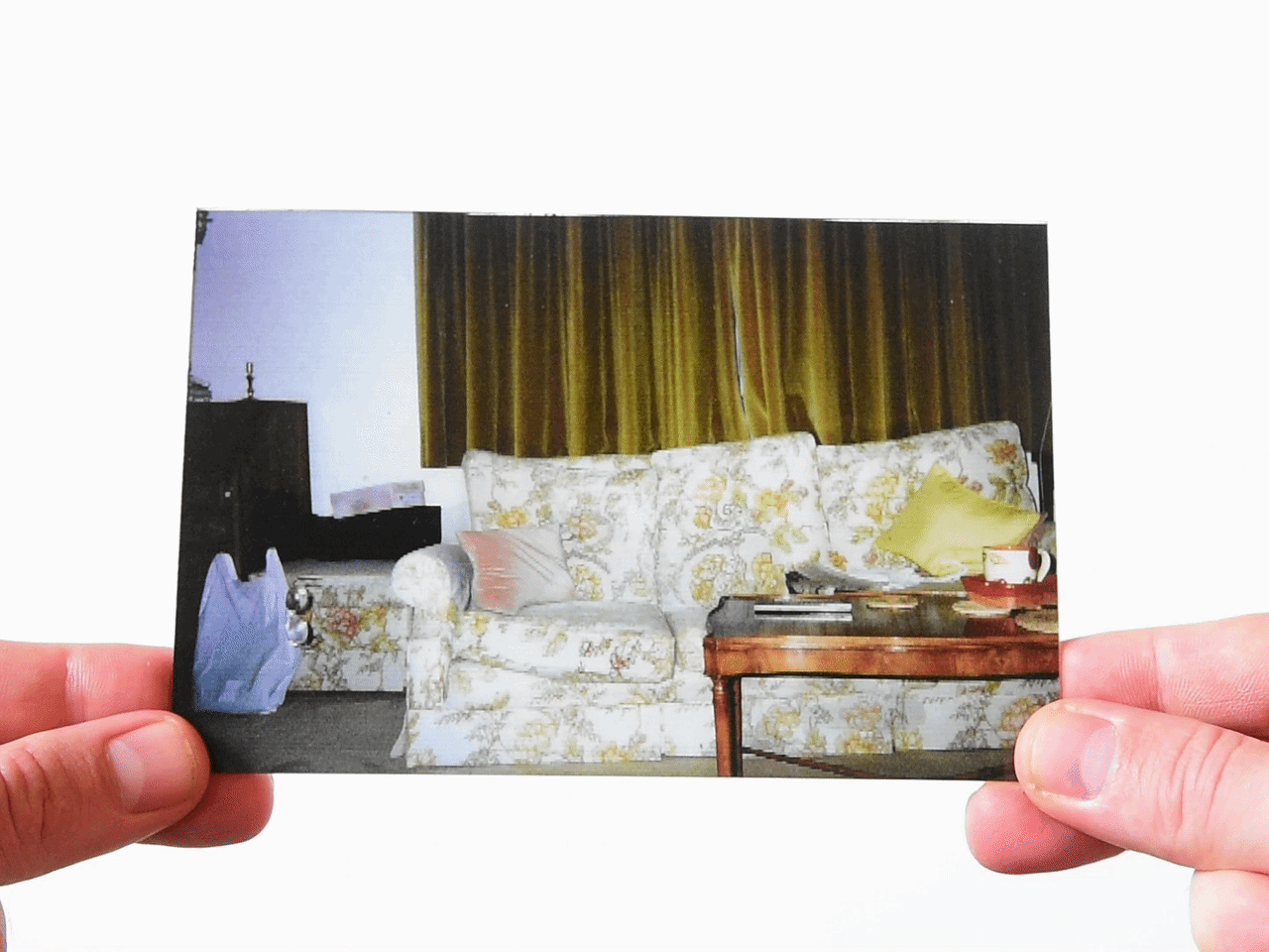Living room with floral couch and coffee table in vintage childhood photo