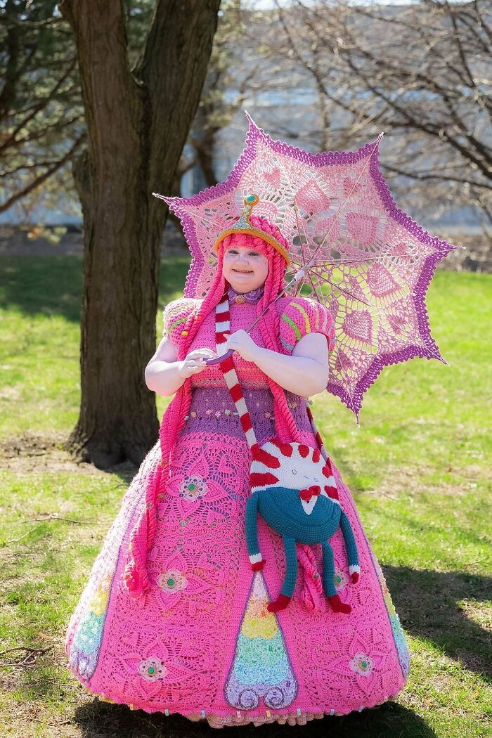 Crocheted pink dress with matching parasol and colorful yarn handbag