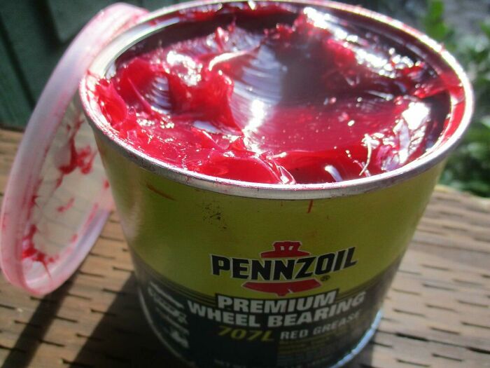 An open can of Pennzoil premium wheel bearing red grease, which is a forbidden food.
