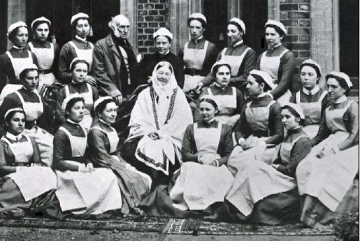 Queen Victoria surrounded by nurses, representing Women In History in healthcare.
