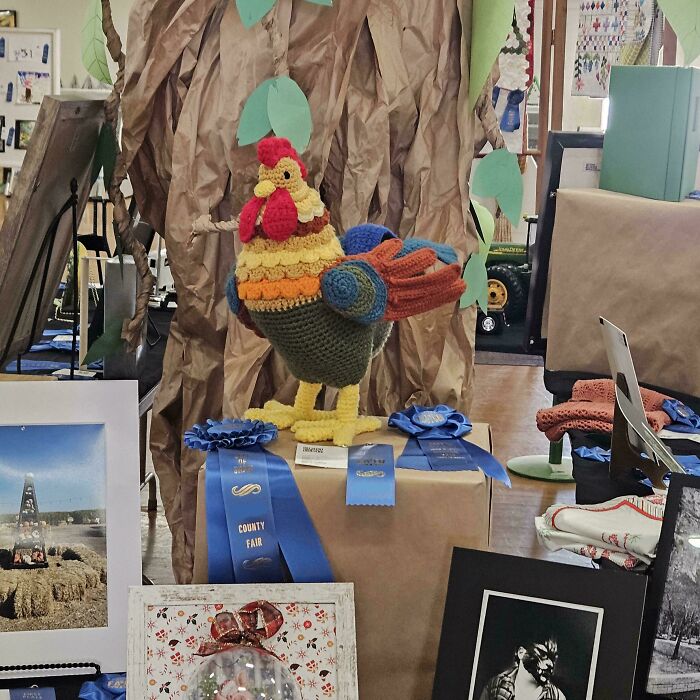 Colorful crochet rooster winning blue ribbons at county fair