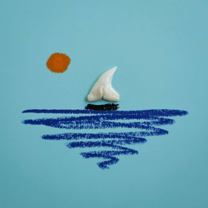 A shark tooth sail on a drawn sea represents everyday objects come to life by Romain Joly