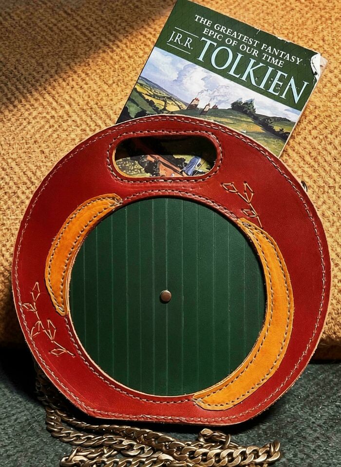 Round leather frog bag with chain and Tolkien book in background