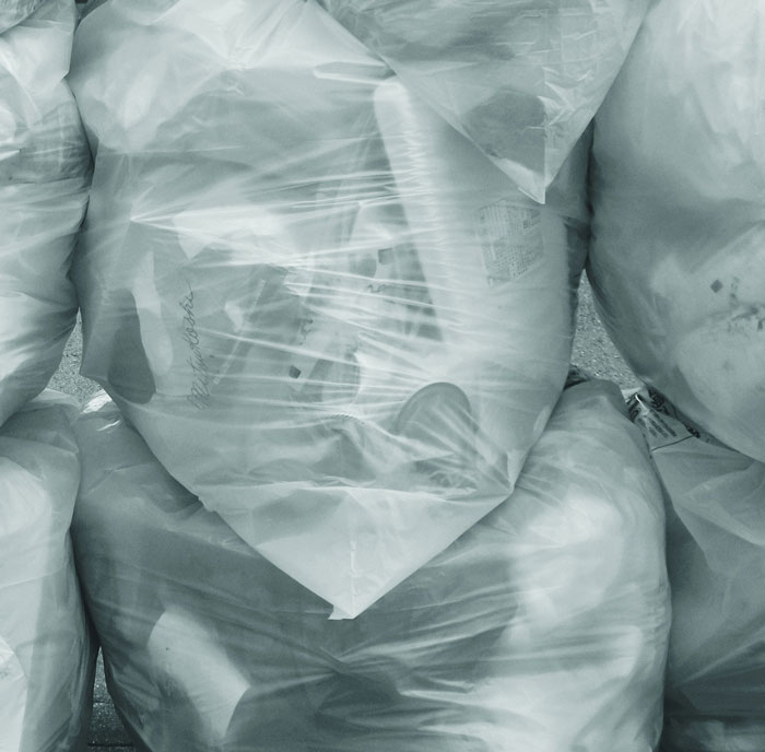Clear garbage bags filled with trash, illustrating messy tenant stories for landlords.