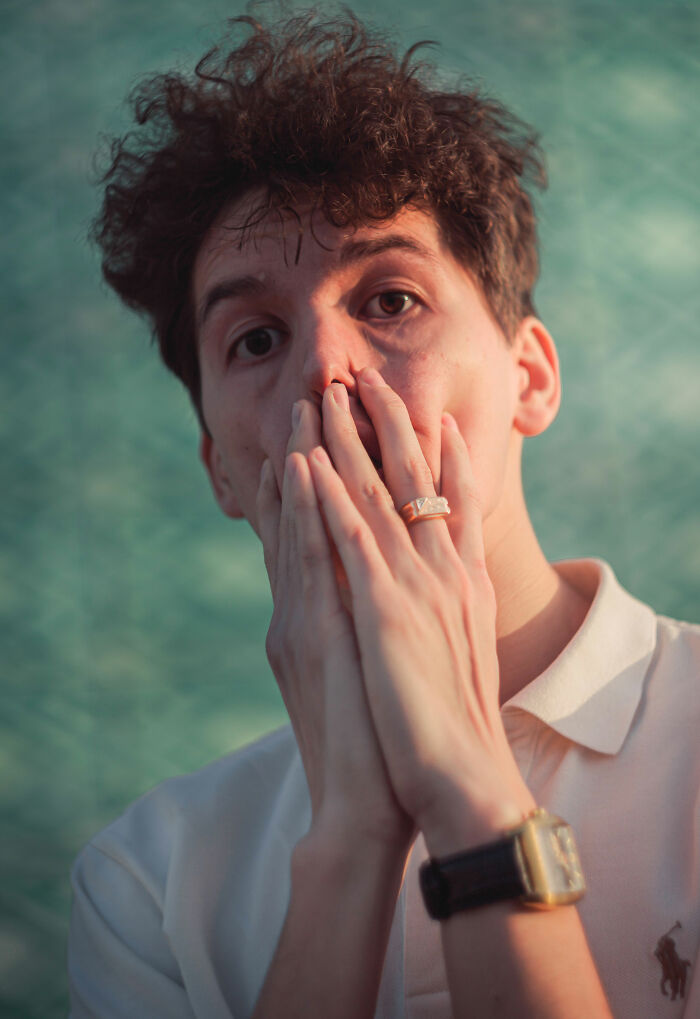 A man covers his mouth, looking surprised, representing entitled people getting a reality check.
