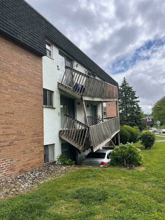 A truly bizarre sight of a car having crashed under a residential building's balcony.