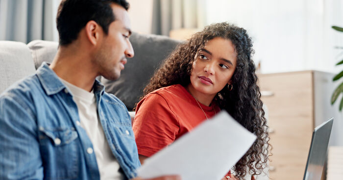 Woman listening attentively to man discussing clever insults indoors
