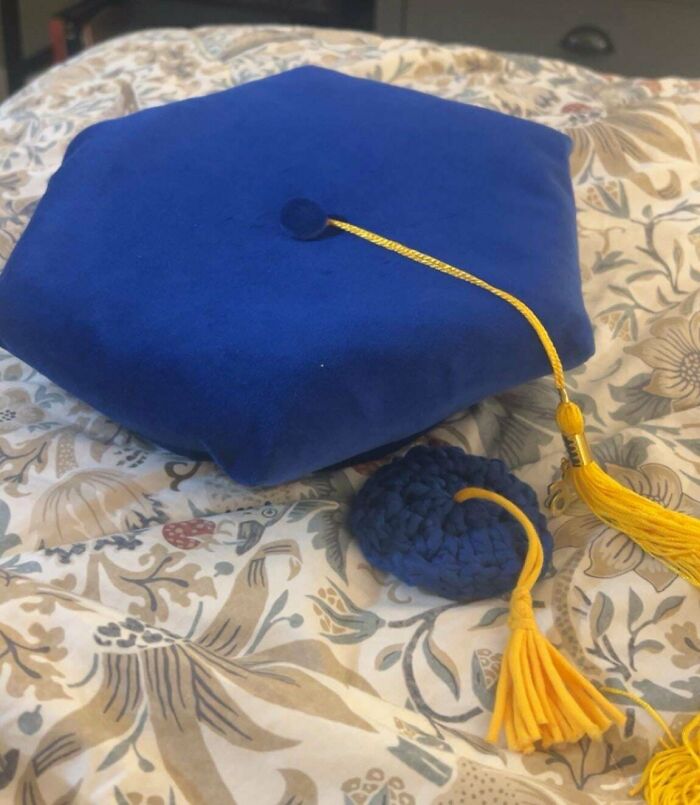 Blue graduation cap with yellow tassel and crocheted detail