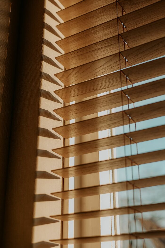 Closed wooden blinds, providing privacy and security for women living alone to protect themselves.