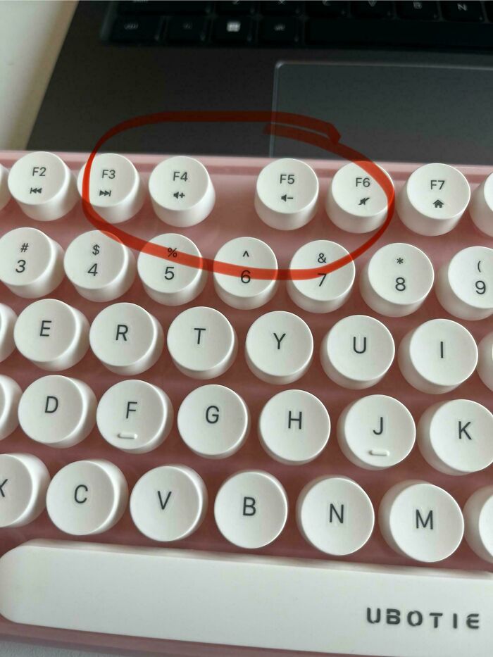A pink keyboard with white round keys, showing a red circle around the F3, F4, F5, F6, 5, and 6 keys, indicating design fails.