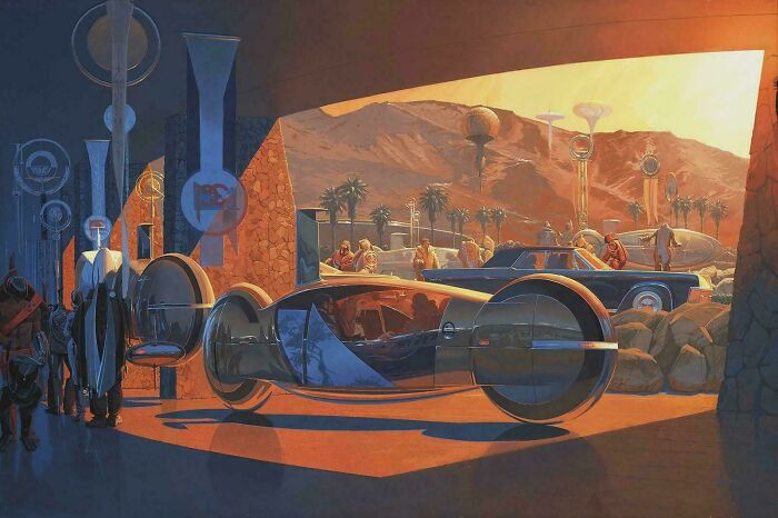 A retrofuturistic vehicle with large wheels in a desert-like setting, illustrating how people imagined the future of cars.