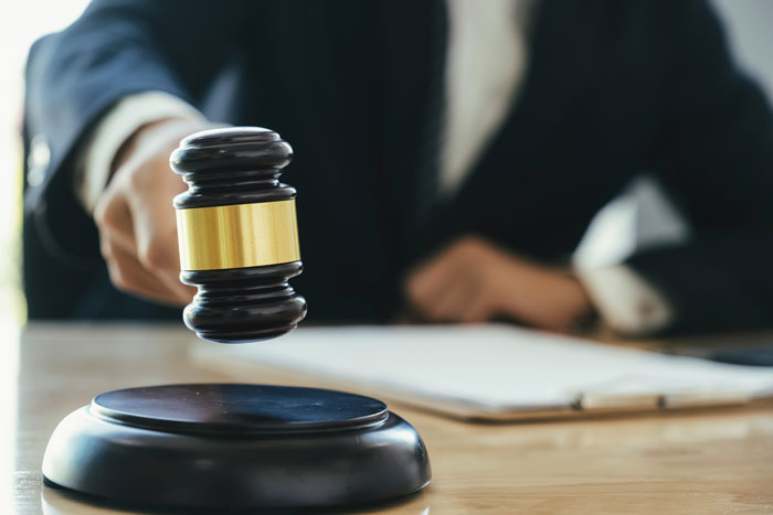 A judge's gavel on a desk, representing the legal implications of tenant stories for landlords.
