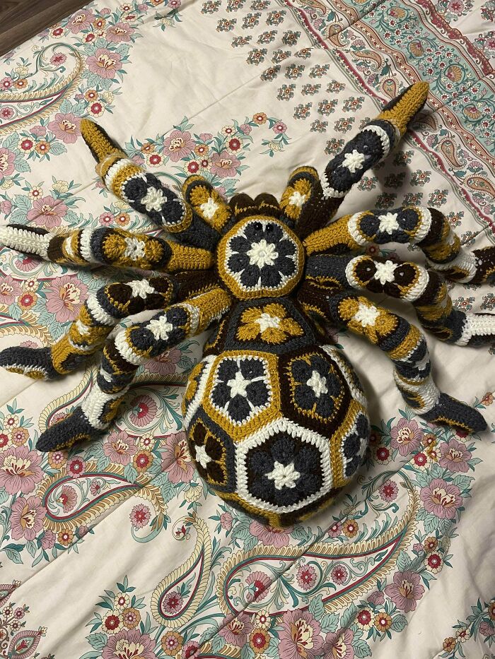 Crochet spider with intricate multicolor patterns made by skilled crocheters