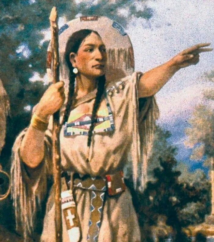 Painting of Sacagawea, a prominent woman in history, pointing forward with a staff.