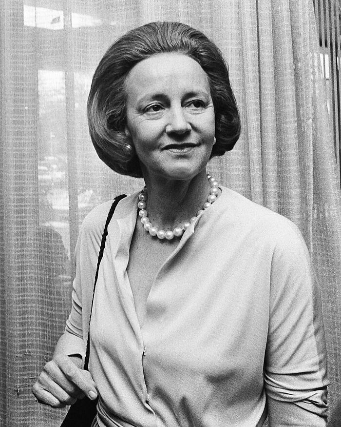 Black and white photo of a woman with a pearl necklace and stylish bob haircut, featuring women in history.
