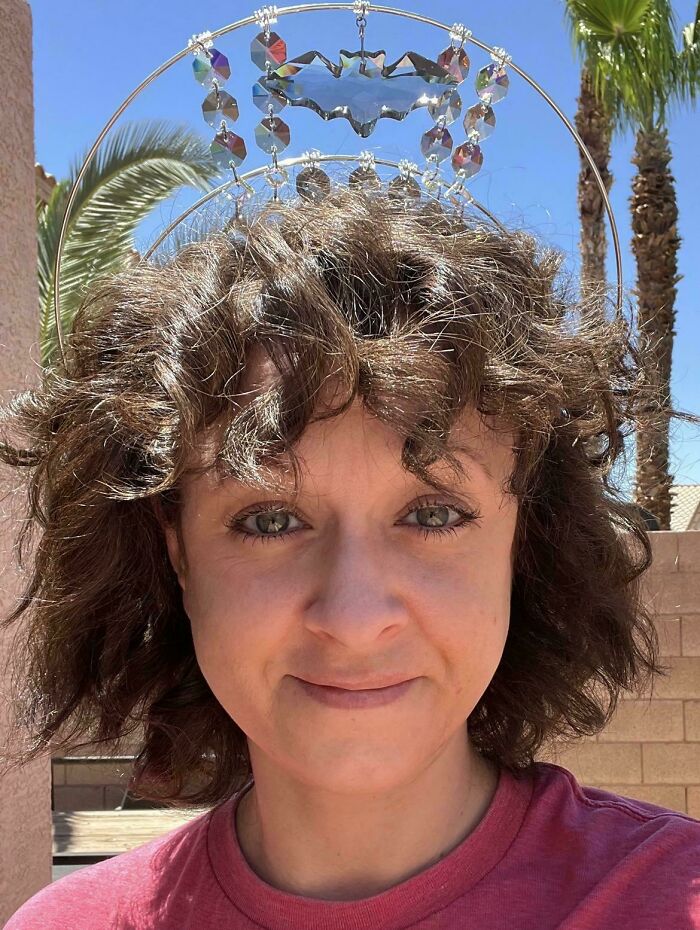 Woman wearing a quirky disco-inspired project headpiece outdoors