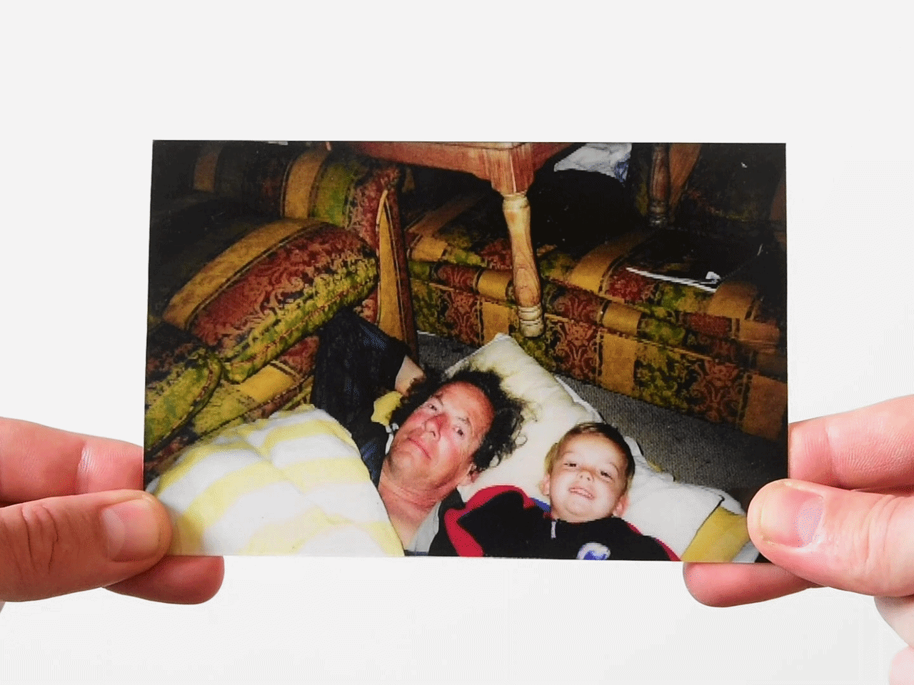 Child and father lying on floor in photo with d**d father removed