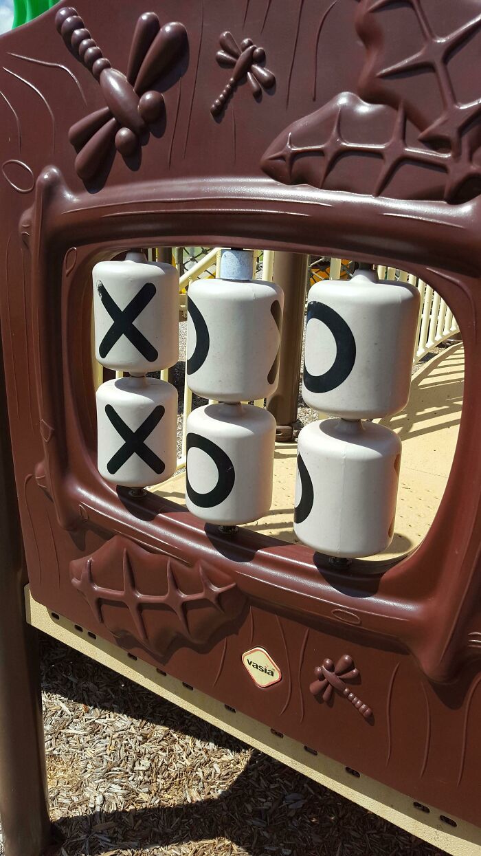 A Tic-Tac-Toe playground game shows X's and O's. This playground design is a fail and looks designed by someone who hates children.