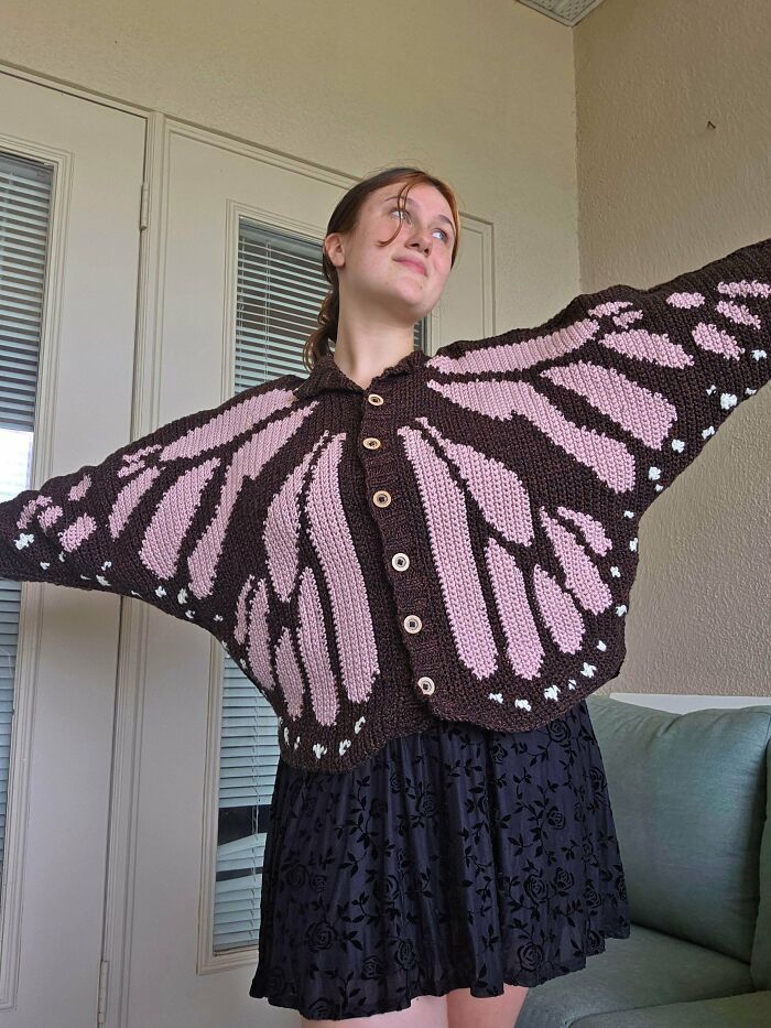 Butterfly wing patterned crochet cardigan worn by model, showcasing crochet talent