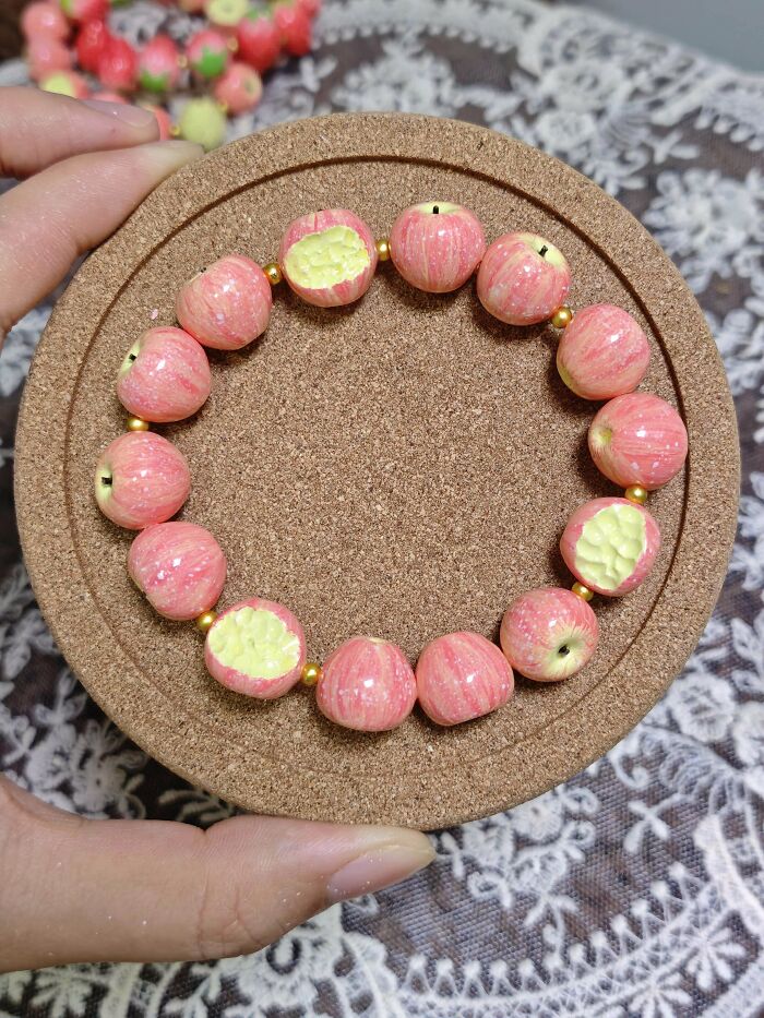 Bracelet made of shiny miniature pink apple beads arranged in a circle