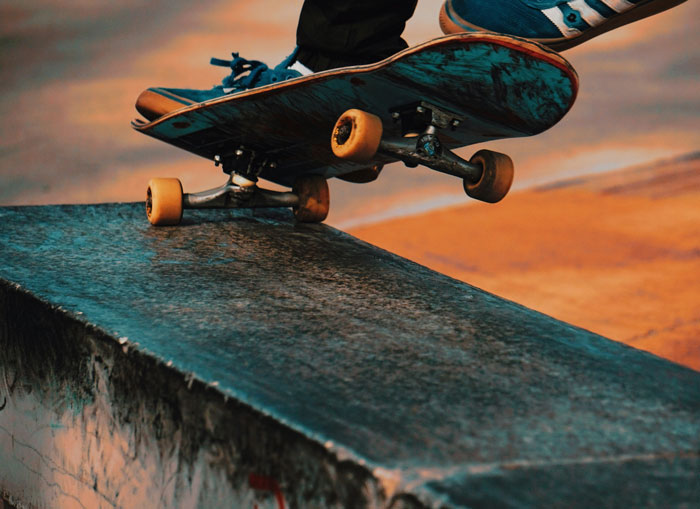 A skateboarder grinding on a concrete ledge with a sunset backdrop, unrelated to nightmarish tenant stories.