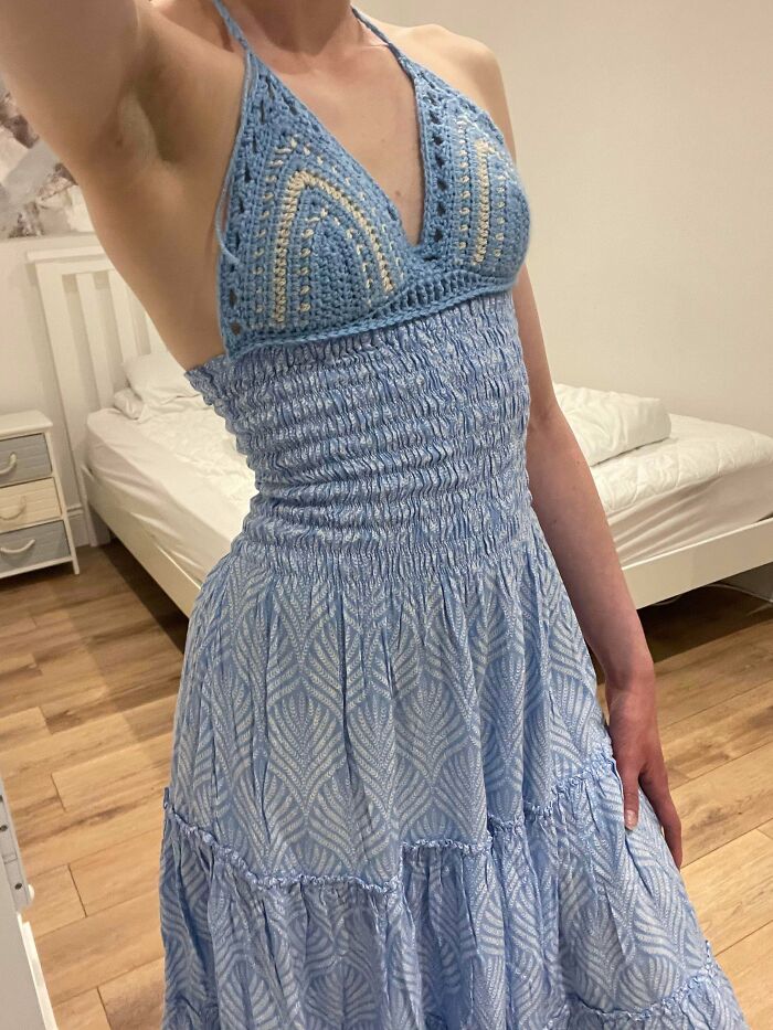 Blue crochet halter top paired with smocked dress showcasing talented crocheters' work