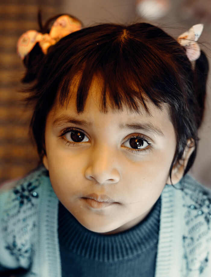Close-up of a young child looking at the camera, conveying the emotions parents might not understand.