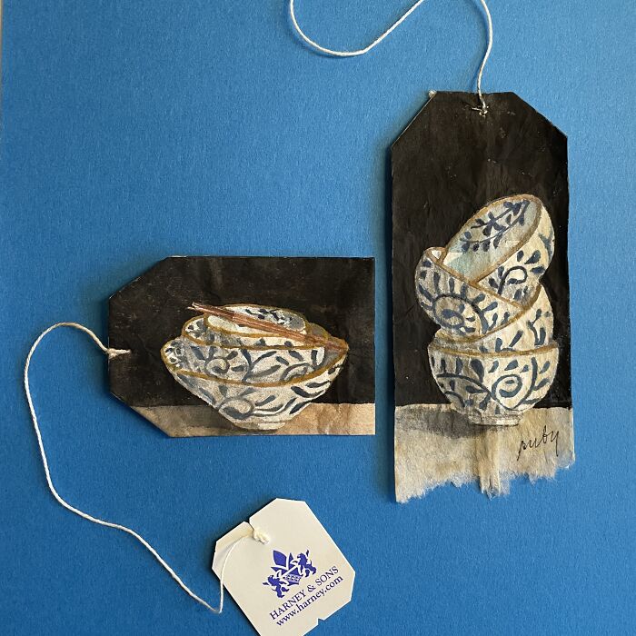 Blue and white ceramic bowls depicted in delicate miniature paintings on dark used tea bags