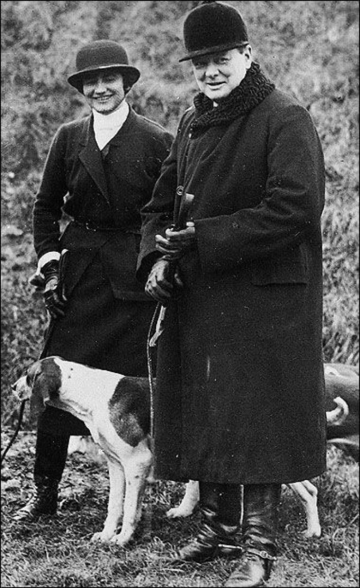 Winston Churchill and Clementine Churchill, prominent figures among Women In History, pose outdoors with a dog.