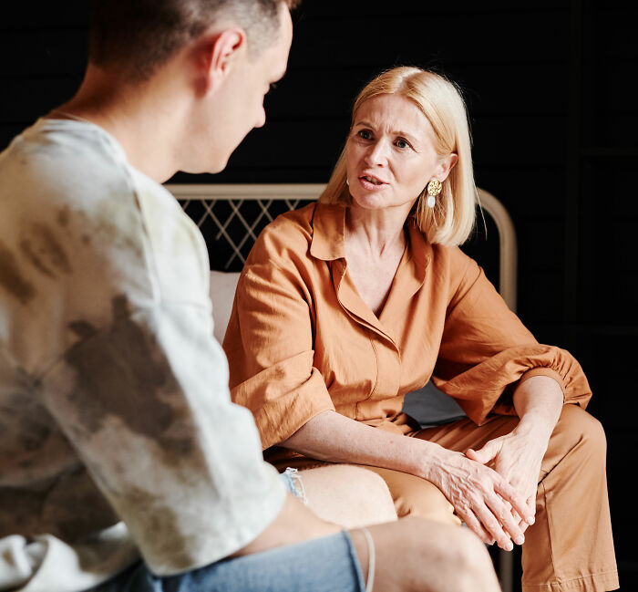 A parent with blonde hair talking to a child, highlighting the moment children finally opened up to parents.