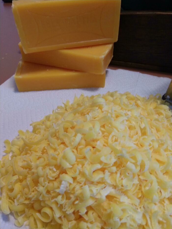 A pile of cheese-like shavings next to bars of soap, which are a forbidden food. Do not eat the soap.