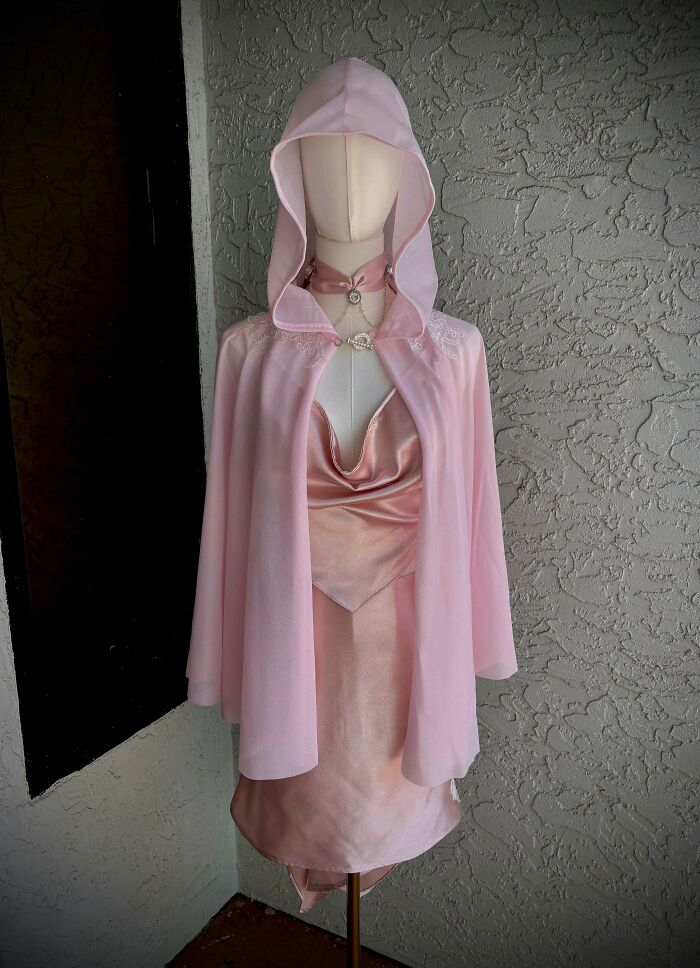 Pink hooded cape with satin dress on mannequin quirky project