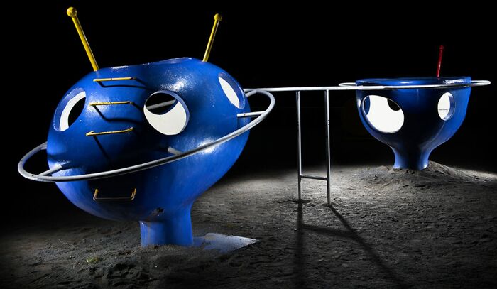 A blue, alien-like Japanese playground structure at night, captured by Fujio Kito, looking like another world scene.