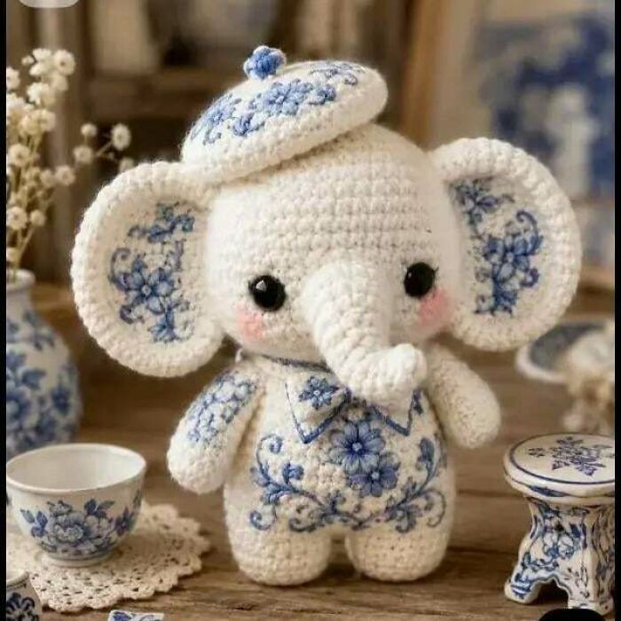 Crocheted elephant doll with blue floral embroidery details