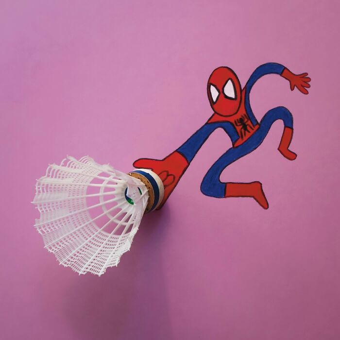 A badminton shuttlecock used as a spiderweb shooter in a playful illustration of Spider-Man.