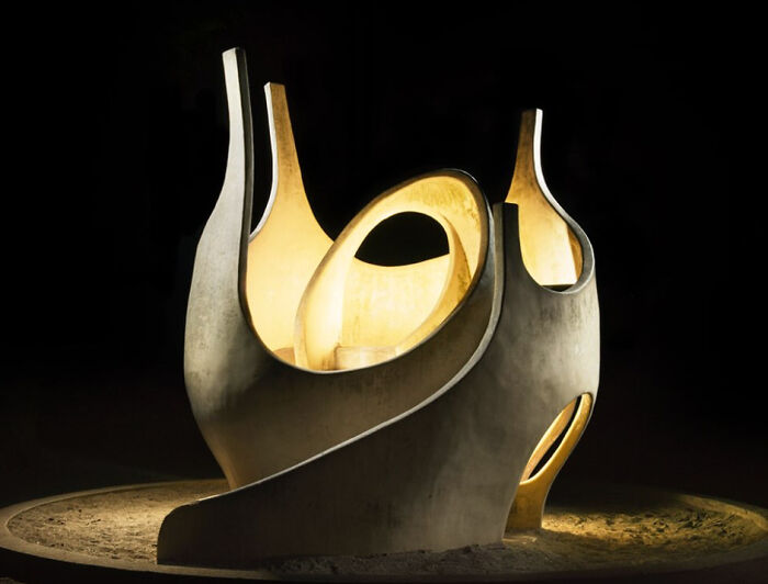 An illuminated, abstract sculpture with flowing lines creates a surreal scene in a Japanese playground at night by Fujio Kito.