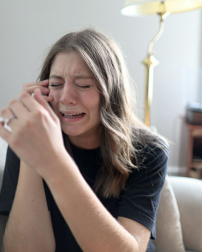 Woman crying, expressing strong emotion, potentially related to a delicious dinner or hot tea experience.