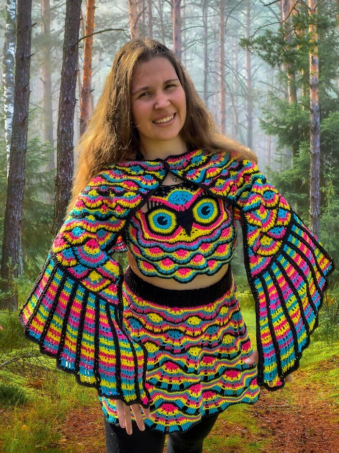 Woman wearing a colorful crocheted owl costume outdoors, quirky project fashion