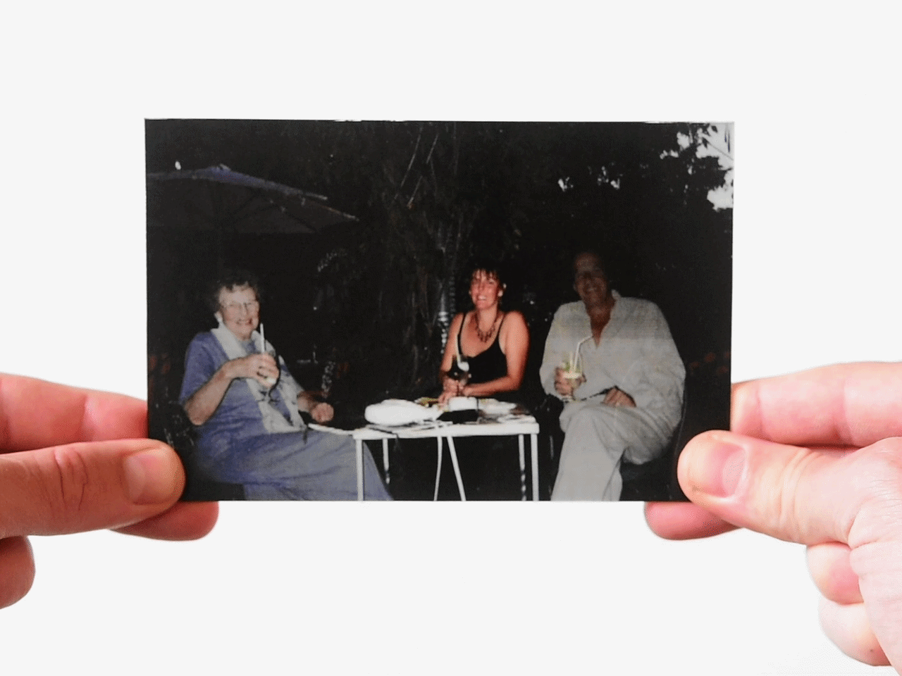 Three women having drinks at table in edited childhood photo