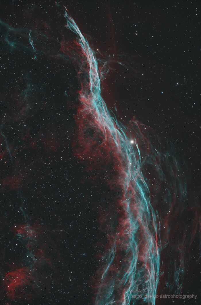 Vibrant astrophotos of nebula with blue and red gaseous filaments in starry night sky