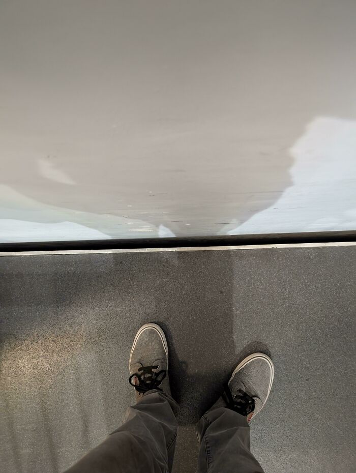 A pair of feet on an airport floor, likely waiting, symbolizing a reality check for entitled people at 30,000 feet.