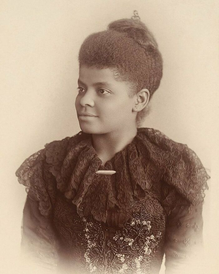 Sepia-toned portrait of Ida B. Wells, a powerful woman in history, wearing an ornate lace dress.