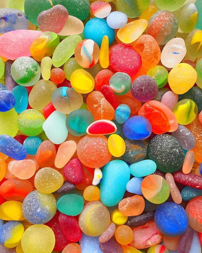 A vibrant collection of colorful, smooth stones that look like forbidden foods or candies.