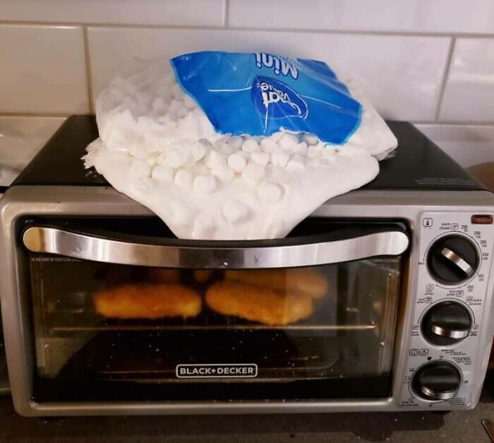 A sticky kitchen fail with a bag of marshmallows melted over the top of a toaster oven, demonstrating a sweet kitchen mistake.