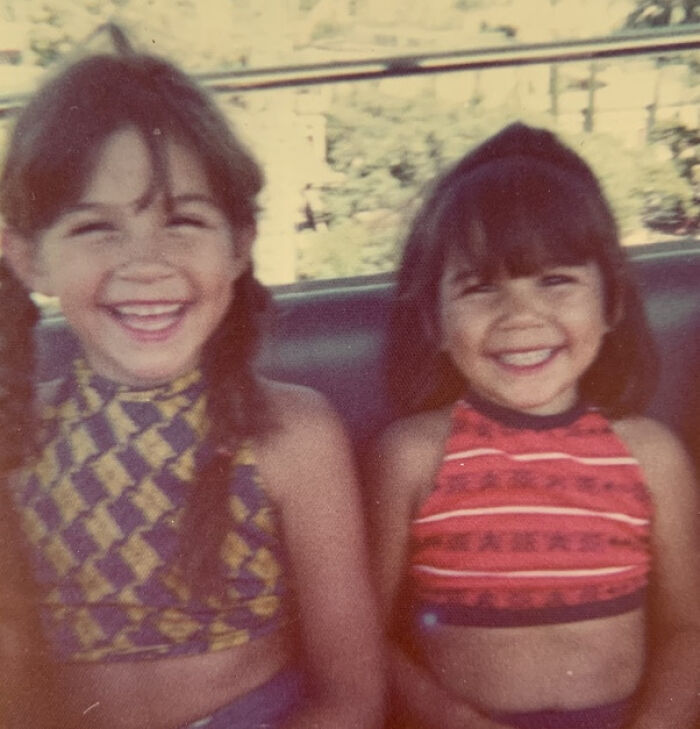 Two young girls smiling, symbolizing children and parents opening up about their past.